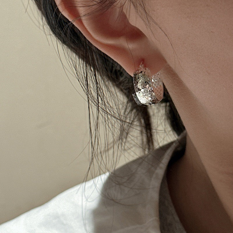 Model ear close-up wearing S925 Sterling Silver Crushed Ice Huggie Hoop Earring