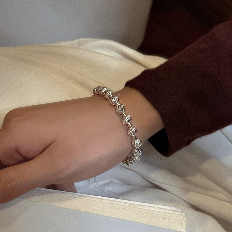 Model wrist wearing S925 Sterling Silver Diamond-Cut Sparkling Bead Bracelet