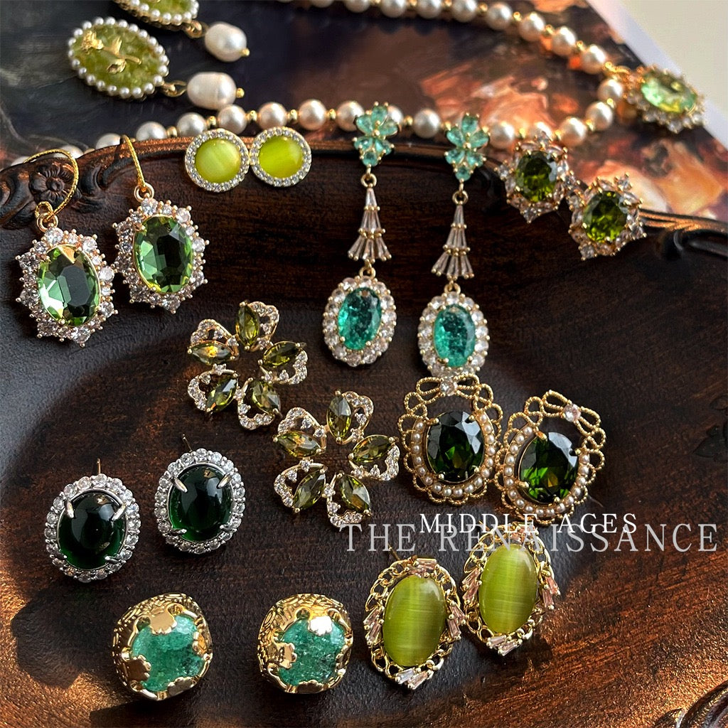 Vintage French Baroque green crystal jewelry collection display on dark wood tray