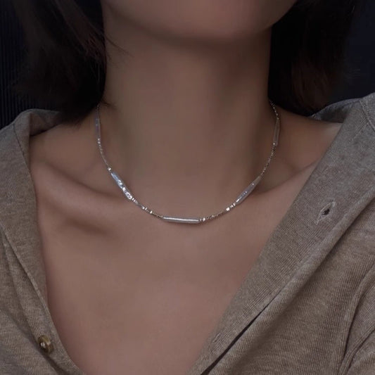 Model wearing Baroque Stick Pearl and Crushed Silver Necklace on camel knitwear