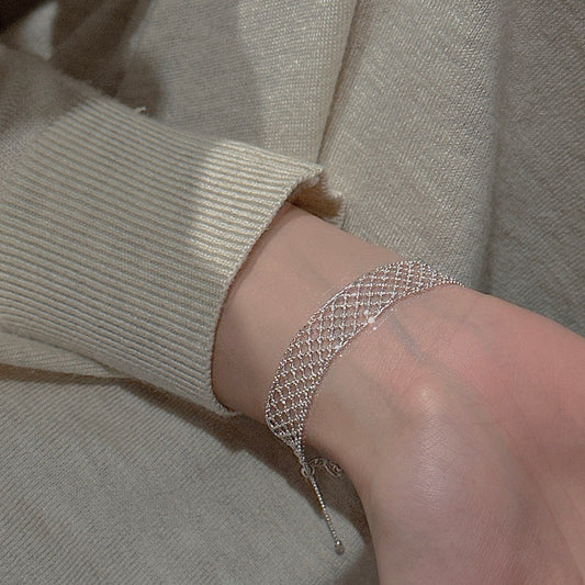 Model wearing S925 Sterling Silver Vintage Mesh Lace Bracelet with Cream Sweater