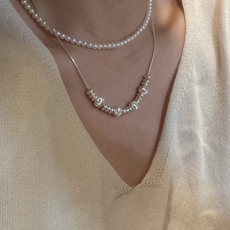Model wearing S925 Sterling Silver Multi-Wear Snake Chain Necklace Layered with Pearls