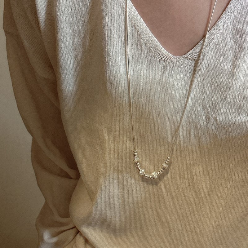 Model wearing S925 Snake Chain Necklace Medium Length on Cream Sweater