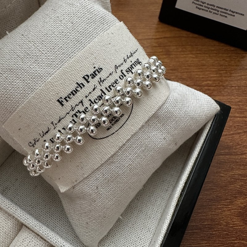S925 sterling silver triple-row woven bead bracelet styled with cream knitted sleeve