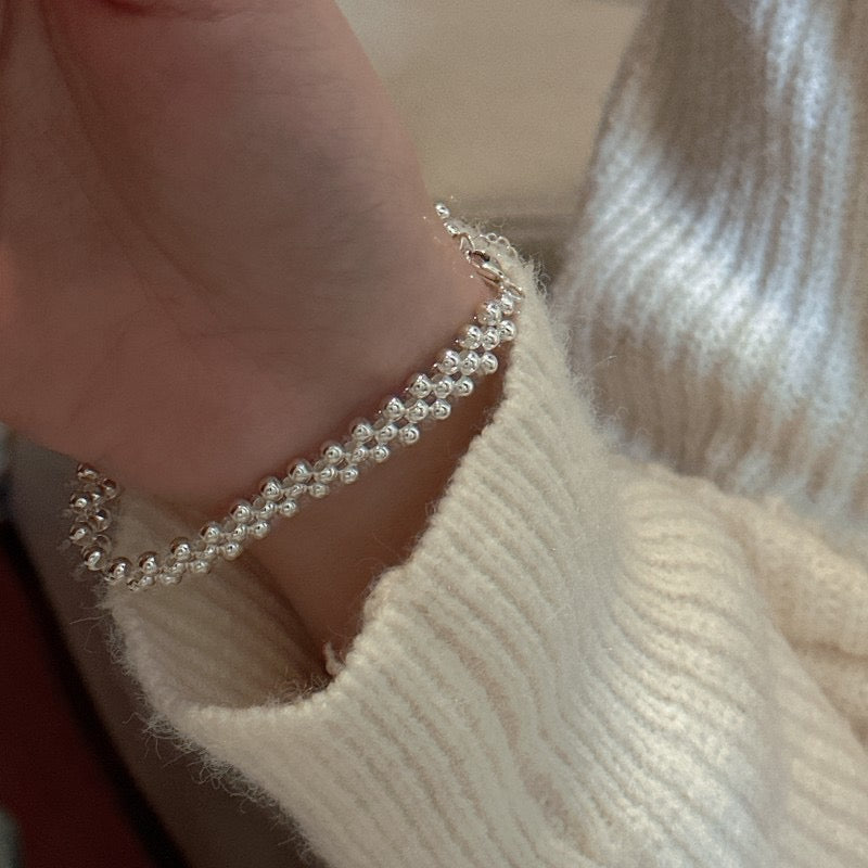 Artisan woven silver bead jewelry collection with matching multi-row rings