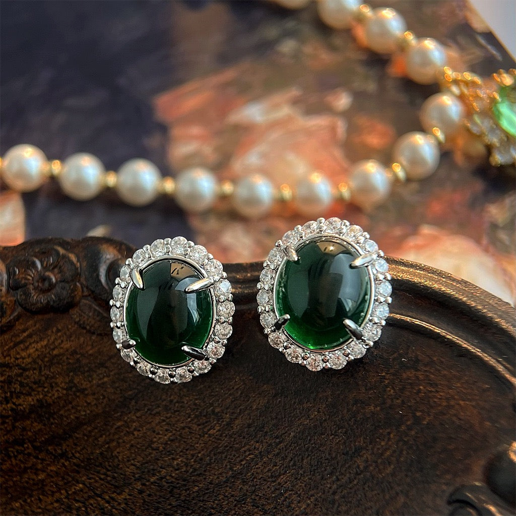 Deep emerald cabochon stud earrings with round pave crystal halo