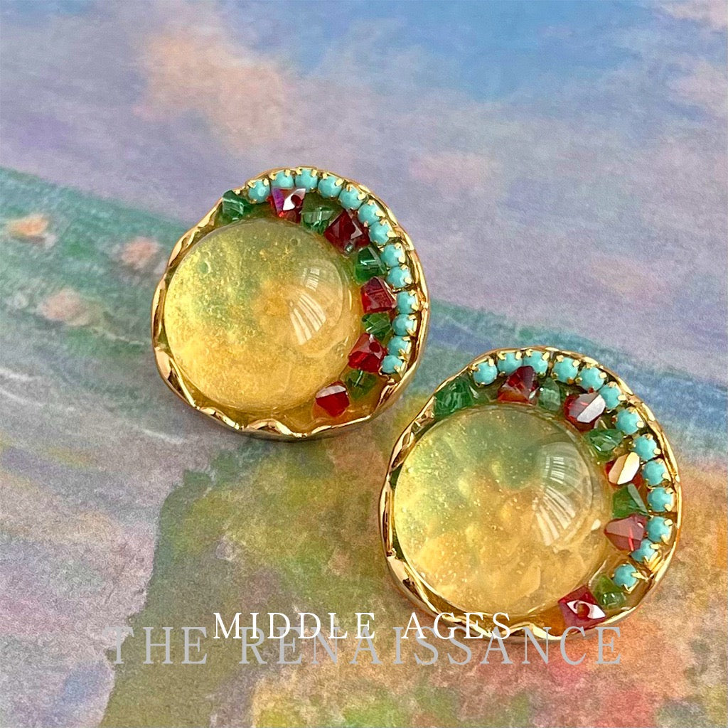Sunlit Garden amber glass earrings displayed on Impressionist oil painting