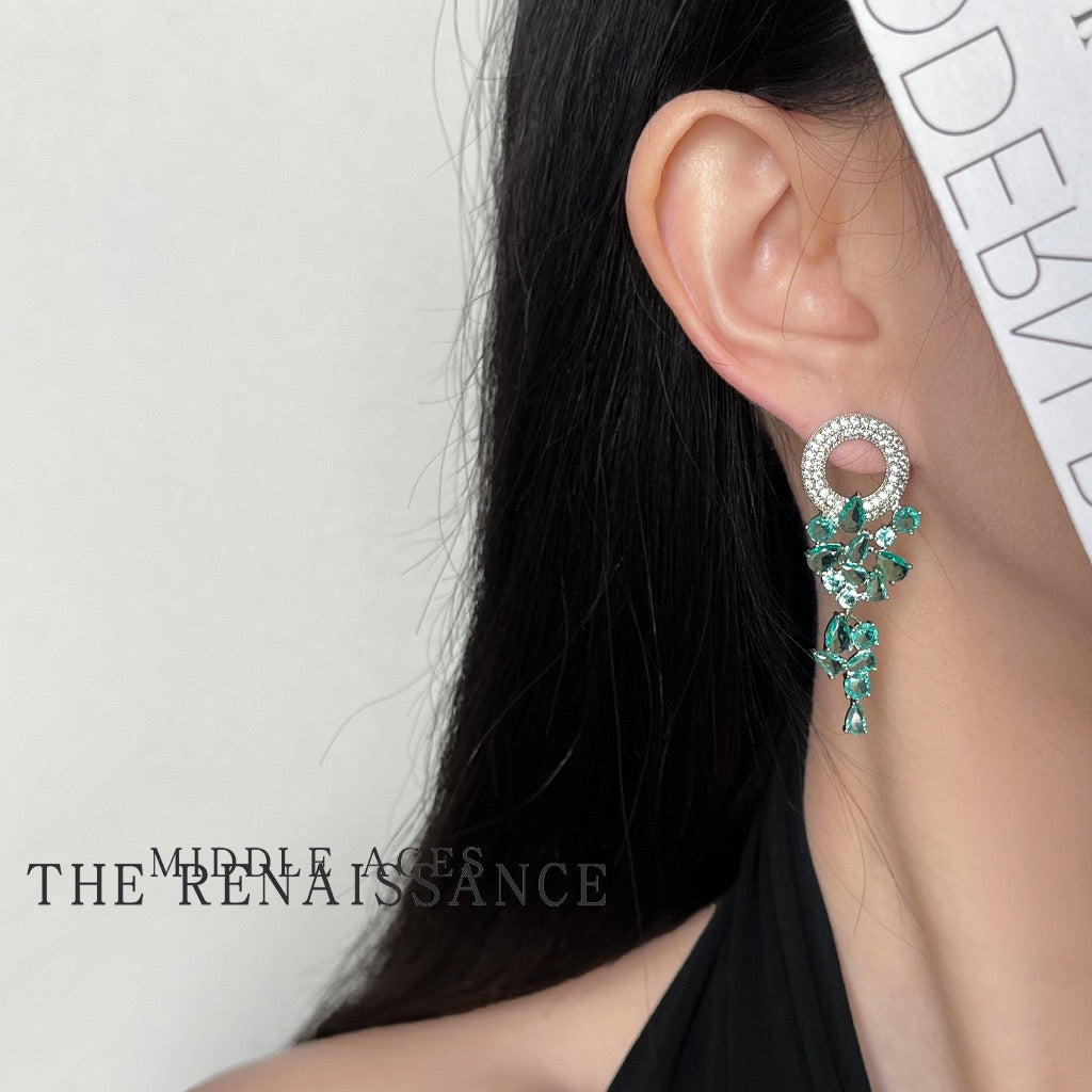 Model wearing vintage green crystal waterfall tassel statement earrings