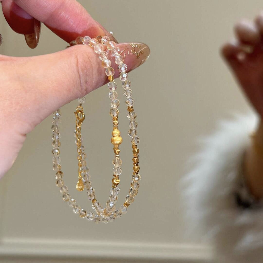 Close-up detail of natural citrine gemstone beads with gold plated clasp and teardrop extension chain